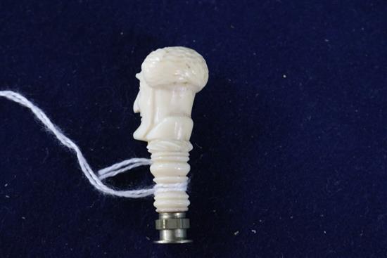 A carved ivory seal, a bone bodkin case and a miniature ivory handled cork screw